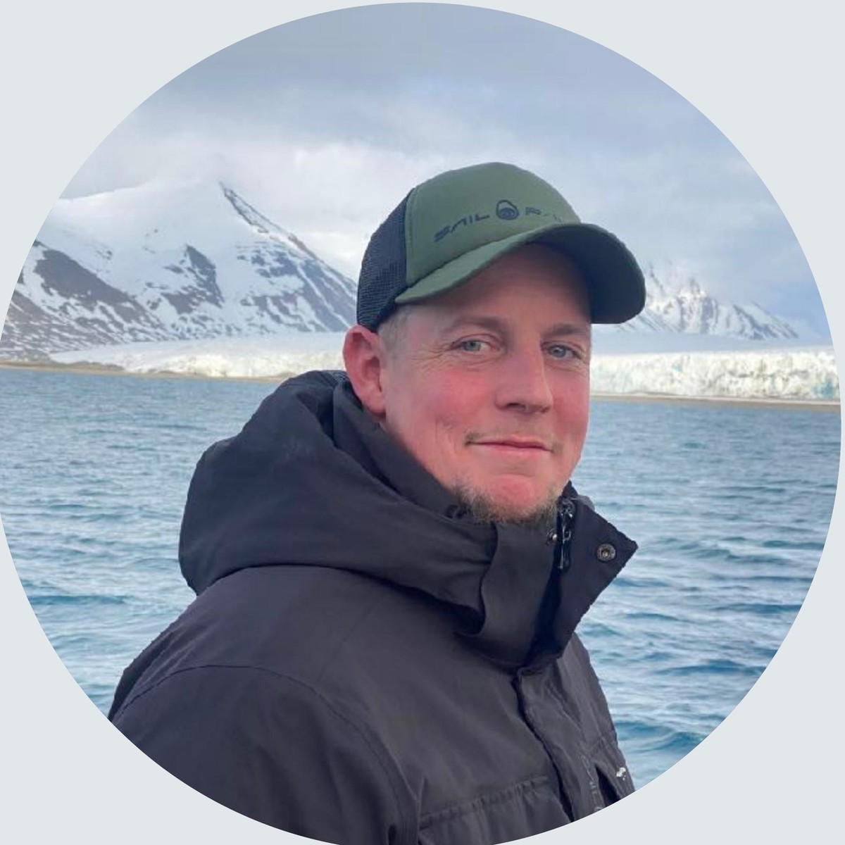 Johannes Schrøder on the water in front of a glacier