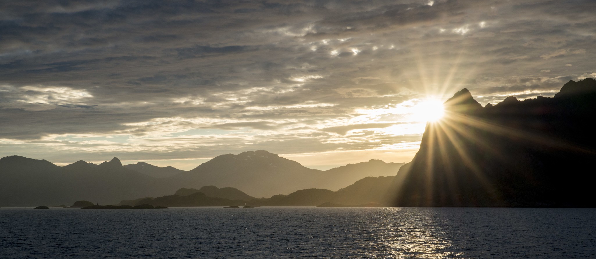 The sun low over the mountains of Arctic Norway